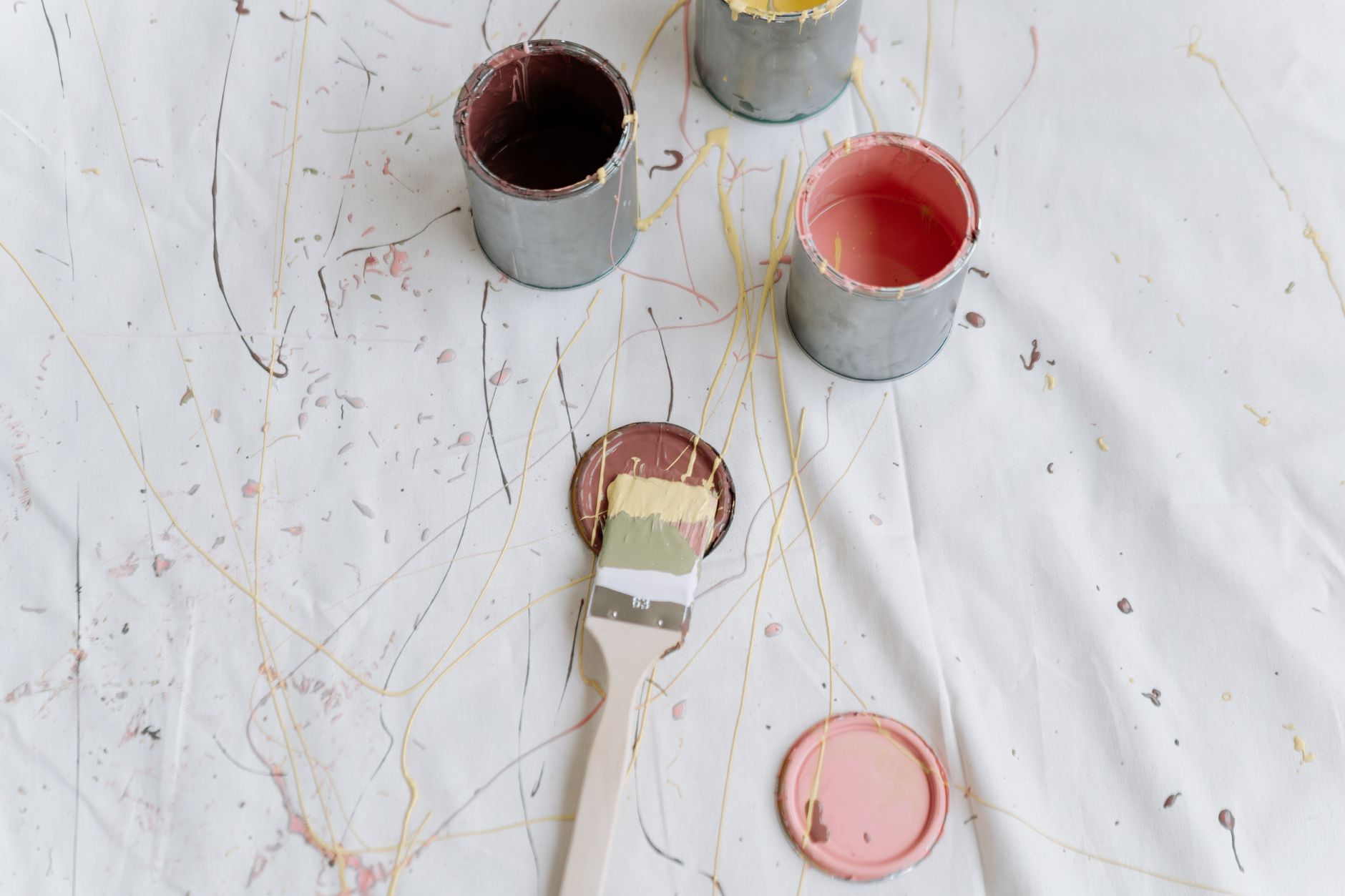 Artistic top-view photo of paint cans and splashes on a canvas, perfect for modern and abstract themes in Temecula, CA